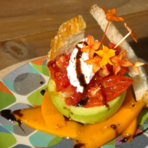 a fruit salad with whipped cream and stars on a plate at Ikurangi Eco Retreat in Rarotonga