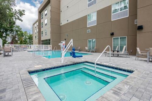 a pool with a slide in front of a building at Holiday Inn Express Melbourne West by IHG in Melbourne