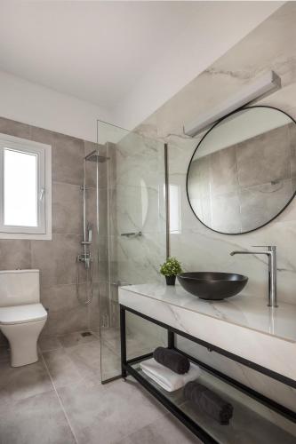 a bathroom with a sink and a mirror at Artemon New Luxury Villa in Skala