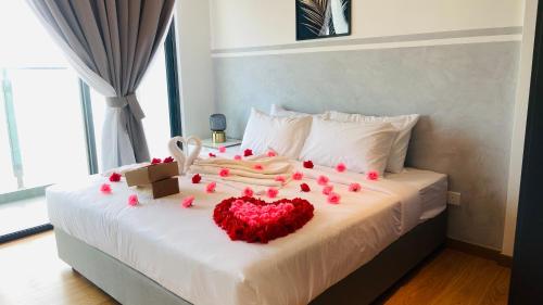 a bedroom with a bed with a heart made out of roses at Kuantan Imperium by Glex in Kuantan