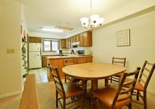 a kitchen with a wooden table and chairs in a room at 200_Primrose in Breckenridge