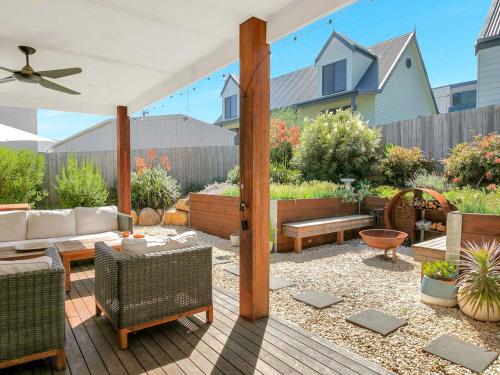 a patio with a couch and a table and chairs at Blue Waves in Smiths Beach