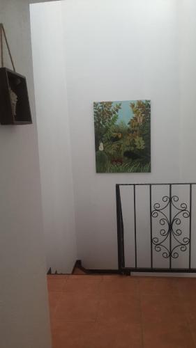 a picture on a wall with a painting on it at La Casita de Naomi in Tamarindo