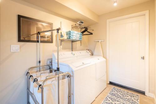 a small laundry room with a washer and dryer at Ocean & Mountain View Home - Walk to Trails Beach Family Activities in Montara