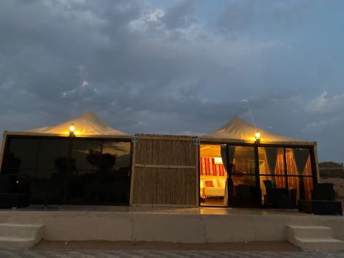 a couple of tents with lights on top of it at Bedouin Oasis Desert Camp- Ras Al Khaimah in Ras al Khaimah