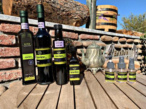 a group of wine bottles sitting on a wooden table at HemDem Alçıtepe in Canakkale