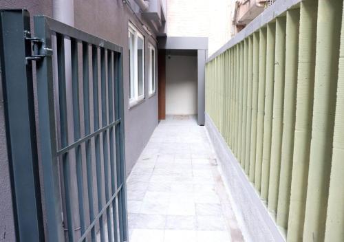 an empty hallway with a gate and a door at Sharman Suites in Pune