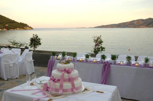 a wedding cake sitting on a table next to the water at Golden View in Poros