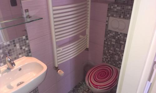 a pink bathroom with a sink and a toilet at Studia Relax in Železná Ruda