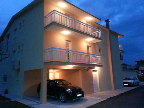 a car parked in front of a building with a balcony at Pansion Turudić in Međugorje