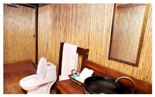 a bathroom with a toilet and a sink at Bedouin Oasis Desert Camp- Ras Al Khaimah in Ras al Khaimah