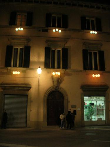 a building with people standing in front of it at night at Palazzo Torriani in Marradi
