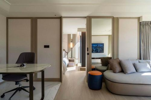 a living room with a couch and a table and a bedroom at Hanns House in Taipei