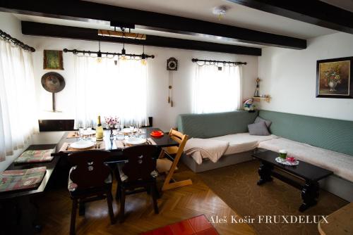 a living room with a table and a couch at Pet & Family Friendly House Viktorija - house near Golica with Triglav view in Jesenice