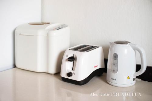 two toasters and a toaster on a counter at Pet & Family Friendly House Viktorija - house near Golica with Triglav view in Jesenice