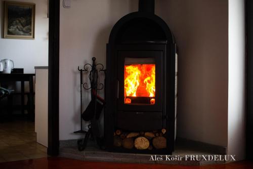 a stove with a fire inside of it at Pet & Family Friendly House Viktorija - house near Golica with Triglav view in Jesenice