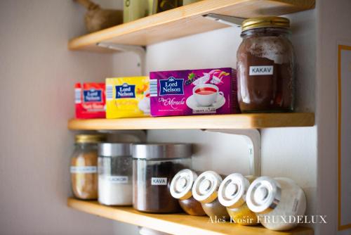 a shelf with jars of food on it at Pet & Family Friendly House Viktorija - house near Golica with Triglav view in Jesenice