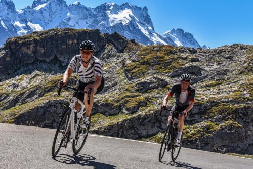 two people riding bikes on a road in the mountains at Chalet 800 in Oz