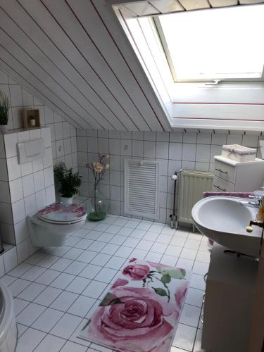łazienka z toaletą, umywalką i oknem dachowym w obiekcie Feriendomizil Nr. 3 w mieście Homburg