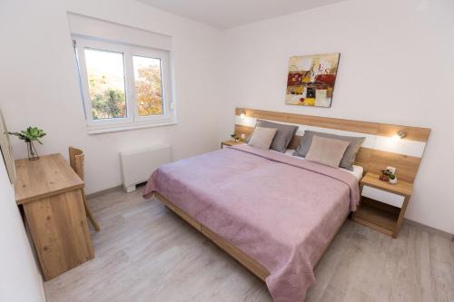 Ένα ή περισσότερα κρεβάτια σε δωμάτιο στο Apartmani Villa Paulo