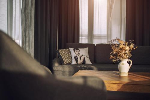 a living room with a couch and a table at Aparthotel Central Liptovský Mikuláš in Liptovský Mikuláš