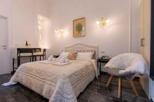 a bedroom with a white bed and a chair at Sant'Ivo Apartments in Rome