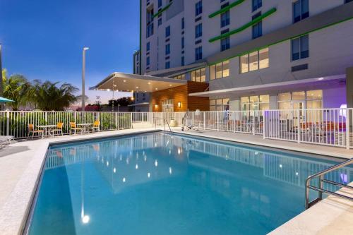a large swimming pool in front of a building at Wyndham Garden Miami International Airport in Miami