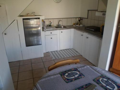 a small kitchen with a table and a sink at After8 B&B in Kleinbaai