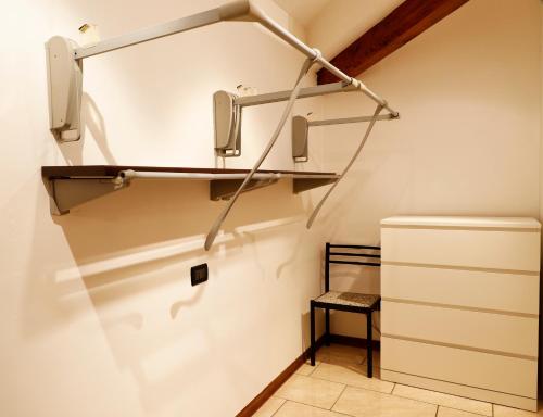 a walk in closet with a shelf and a stool at Emily House Vignola in Vignola