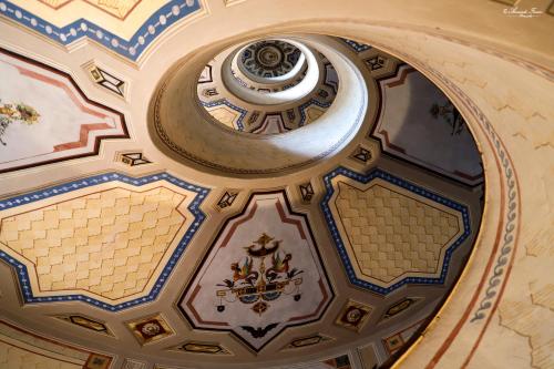 an ornate ceiling of a building with a dome at Emily House Vignola in Vignola