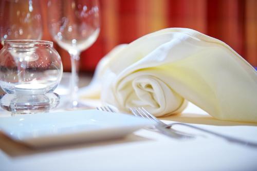 a table with a napkin and a glass of wine at Hotel TURNA Malbun in Malbun