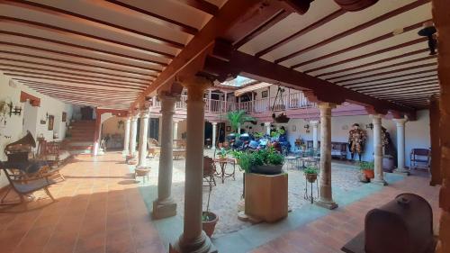 an outdoor patio with a large wooden pergola at Hotel Rural Posada Los Caballeros in Almagro