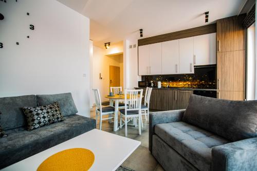 a living room with a couch and a table at Apartamenty Ola in Lębork