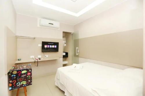 a hospital room with a bed and a flat screen tv at TERESINA HOTEL in Teresina