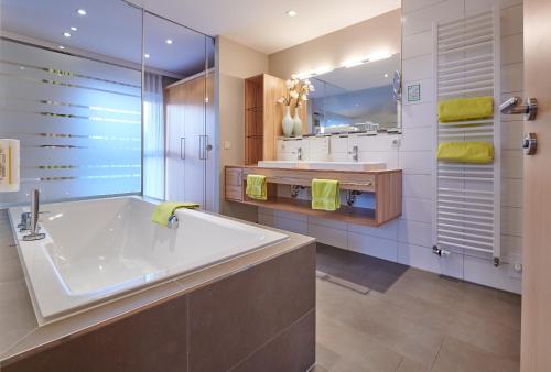 a large bathroom with a tub and a sink at Inntalhof in Kirchdorf am Inn