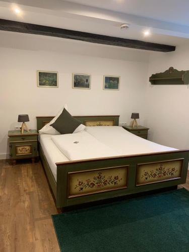 a bedroom with a large bed and two night stands at Hotel zum Braunen Hirschen in Bad Driburg