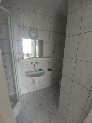 a small bathroom with a sink and a mirror at Ośrodek Wczasowy HELIOS in Jastrzębia Góra