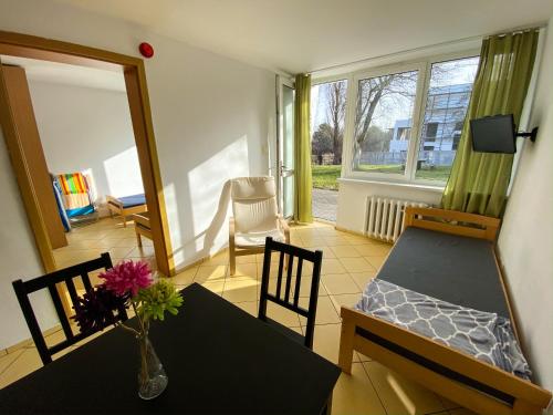 a living room with a table and a dining room at Ośrodek Wczasowy HELIOS in Jastrzębia Góra