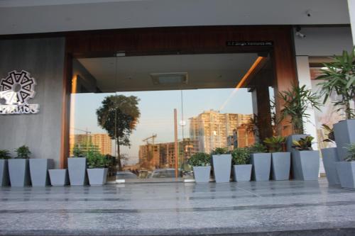 a building with a bunch of plants in front of a building at Anande (The Boutique Hotel) in Sohāna