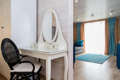 a bathroom with a dressing table and a mirror at Muskatel Boutique Hotel in Gurzuf