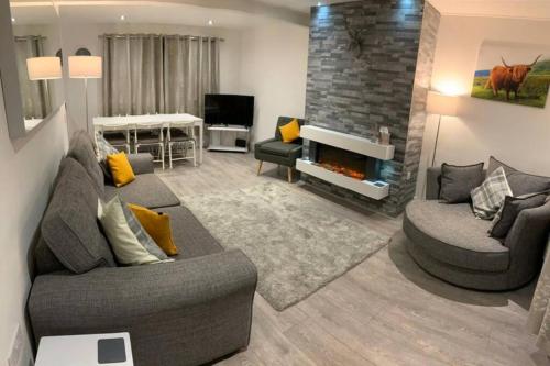 a living room with two couches and a fireplace at *STUNNING & SPACIOUS* 3 Bed House, 5min from Oban in Connel