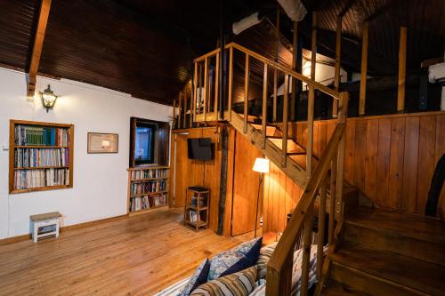 a living room with a staircase and a couch at Casa do Coentral a sua casa Rustica in Lousa