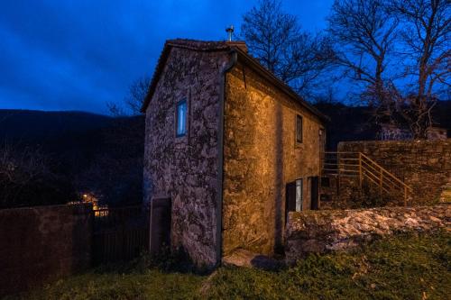 a stone building with a window on the side of it at Casa do Coentral a sua casa Rustica in Lousa