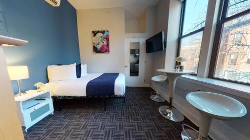 a hotel room with a bed and a window at South End Studio, Ideal for Boston Travelers #23 in Boston