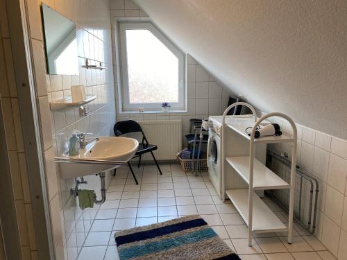 a small bathroom with a sink and a sink at 50188Ferienwohnung Windspiel in Harlesiel