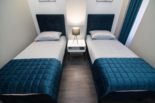 Postel nebo postele na pokoji v ubytování Apartments Azzurro Sarajevo