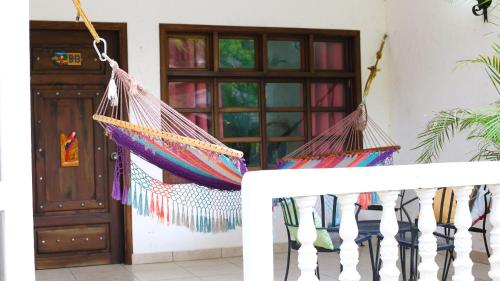 a porch with two hammocks hanging from a fence at Hotel Ciudad Blanca in Copan Ruinas