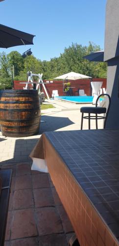 a patio with a table and a water fountain at Kuća za odmor Mladen i Martina in Slavonski Brod