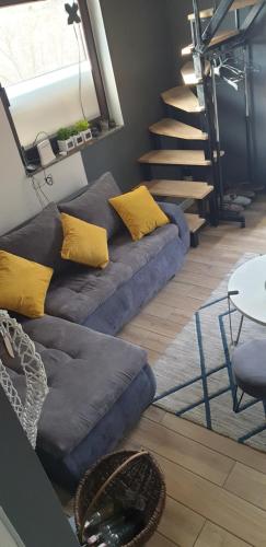 a living room with two blue couches and a staircase at Kuća za odmor Mladen i Martina in Slavonski Brod