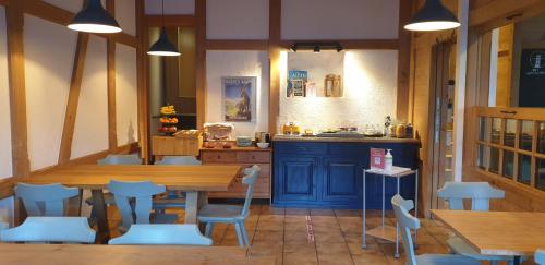 a room with a table and chairs and a kitchen at The Aarburg Hotel & Café in Interlaken